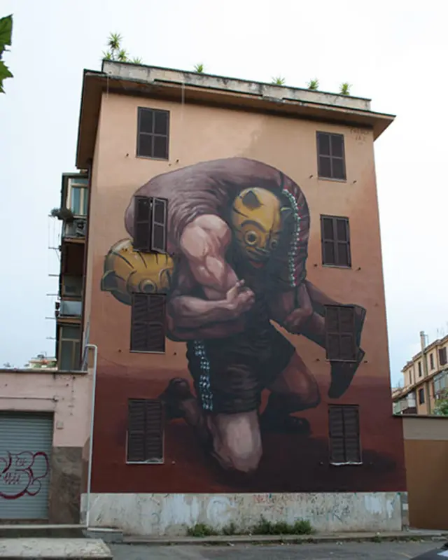 Mural del grafitero argentino JAZ, se ven hombres luchando