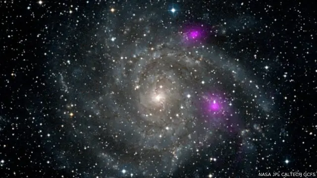 У 2012 році Nustar зафіксував, що дві чорні діри поблизу спіральної галактики IC 342 випромінюють рентгенівські промені високої енергії (на фото виділені фіолетовим)