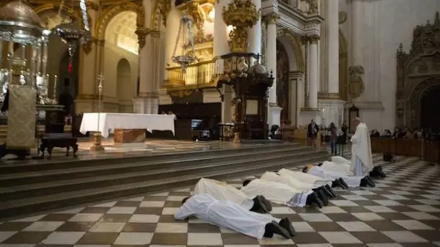 Uskup Granada dan beberapa pastor menelungkupkan diri di depan altar sebagai tanda permohonan maaf.