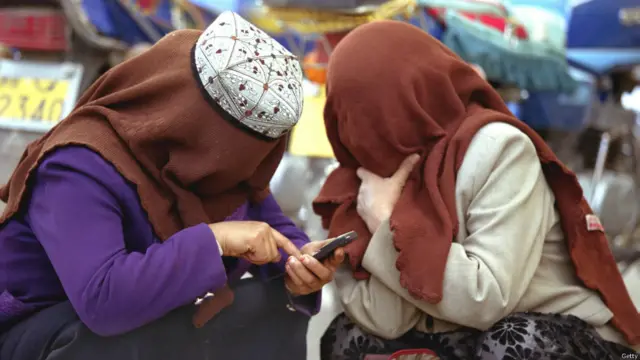 新疆两位穆斯林妇女用手机