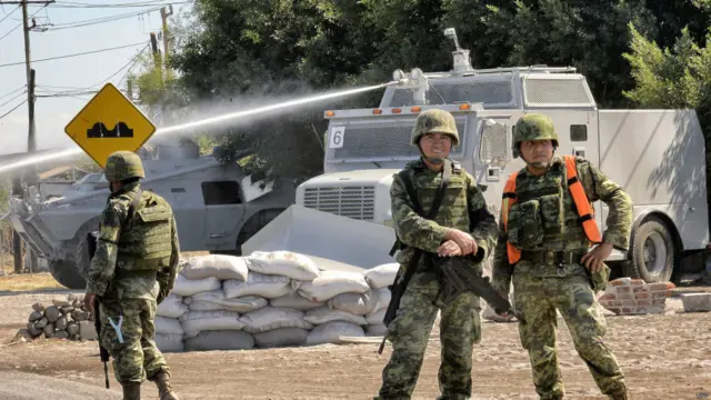 墨西哥米却肯州阿帕钦甘一群士兵在防暴水龙车前站岗（10/1/2015）