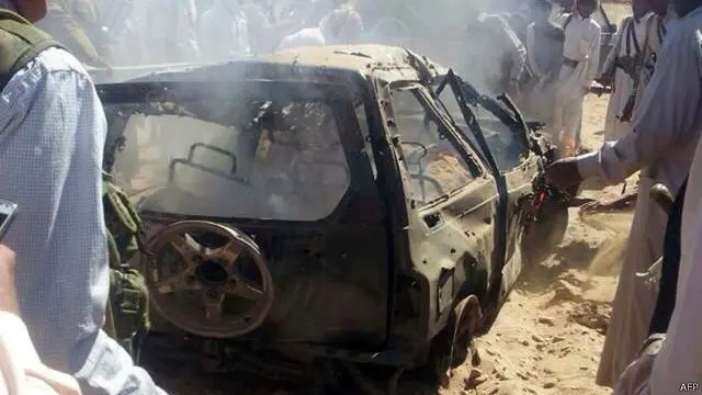 يمنيون تجمعوا حول سيارة استهدفتها طائرة دون طيار في يناير/كانون الثاني بين محافظتي مأرب وشبوة. 