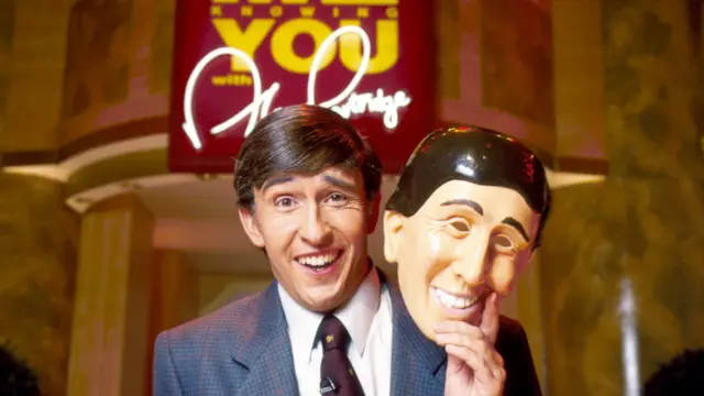 Steve Coogan sebagai Alan Partridge yang sedang membawakan acara serial komedi 'Knowing Me Knowing You'.