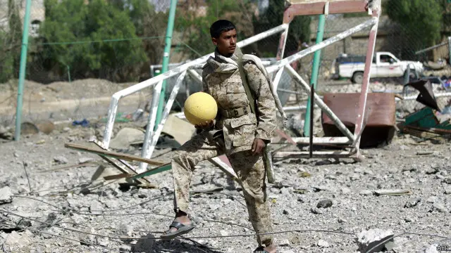 مسلح حوثي في ملعب اليرموك لكرة القدم الذي قيل إنه أصابته غارة جوية سعودية.