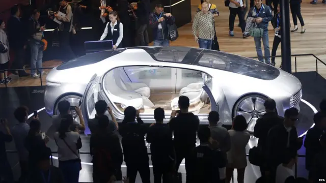 Visitors look at a Mercedes-Benz F 015 Luxury in Motion concept car on display at the 16th Shanghai International Automobile Industry Exhibition in Shanghai, China, 21 April 2015.