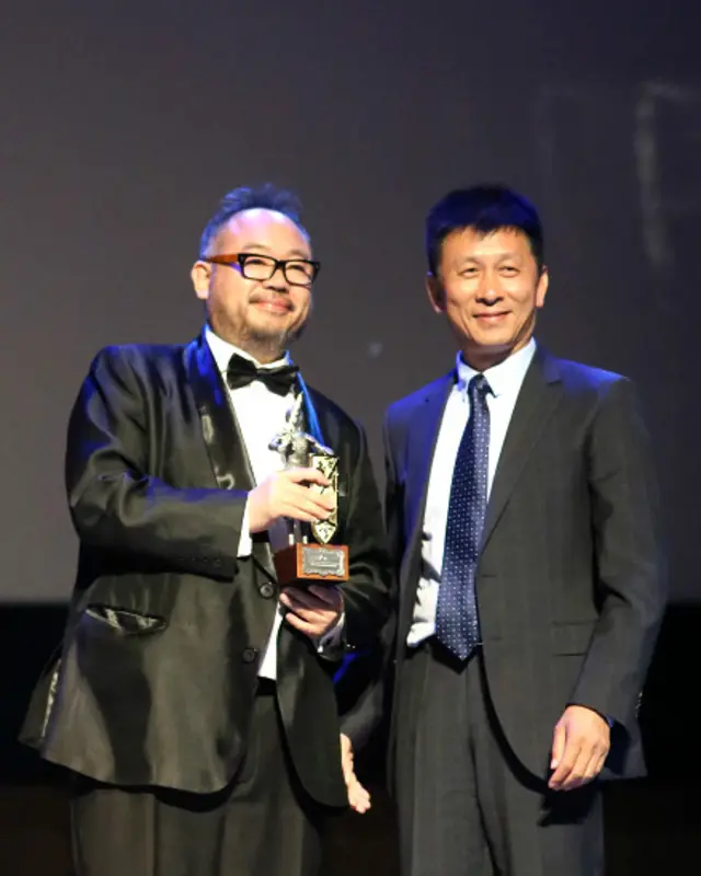 张一白（左）从中国电影局副局长周建东手中领奖（摄影：赵辉）