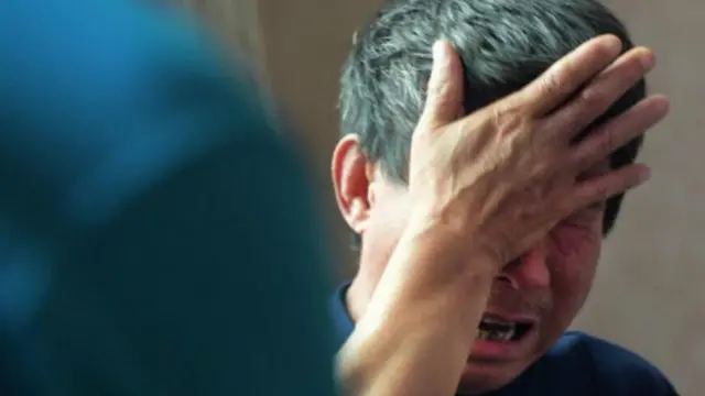 吳建強在回憶自己的逃生經歷的時候，沉浸於痛苦之中。