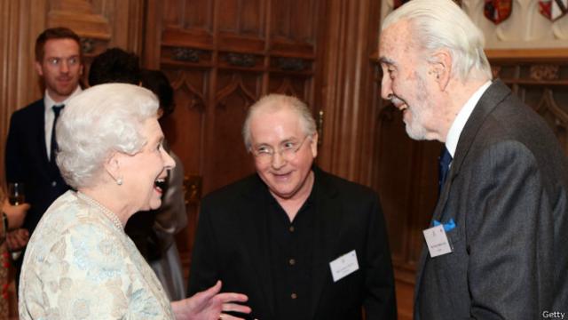 Christopher Lee (der.) con la reina Isabel II