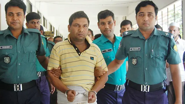 Salah satu tersangka, Muhith Alam, dituntun menuju tahanan polisi.