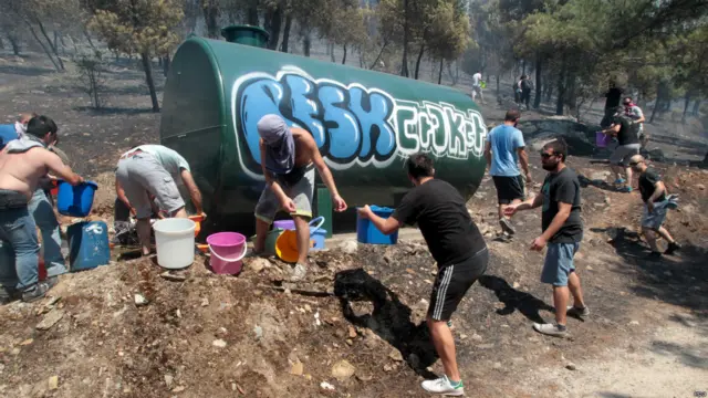 في منطقة كيريا شارك عدد من السكان في مواجهة النيران باستخدام الدلاء.