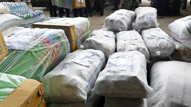 Locals donate relief aid supply for flood victims at the Air Force base in Yangon