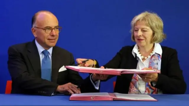 法国内政部长卡泽内夫和英国内政大臣特雷莎·梅（右）8月20日签署合作协议，承诺两国共同打击偷渡和缓减加莱移民危机。