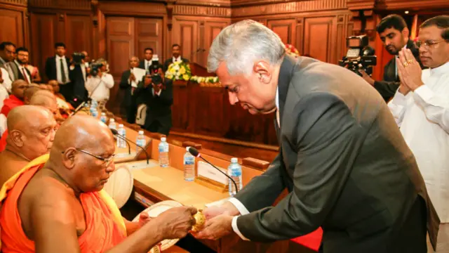 කෝට්ටේ පාර්ශ්වයේ අතිගරු මහානායක නා හිමියන් අගමැතිවරයා අත පිරිත් නූල් ගැට ගසා සෙත් පතන ලද මොහොත.