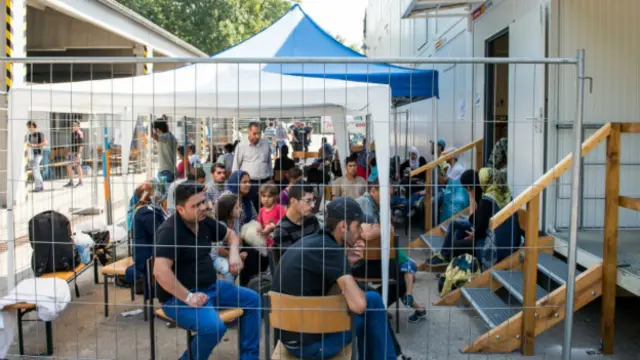 پناهندگانی که از مرز اتریش وارد شهر دگندورف شده و منتظرند نام خود را در دفتر پلیس فدرال ثبت کنند