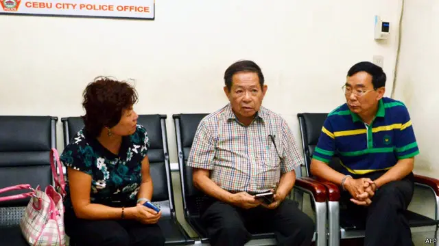 Hai nghi phạm, bà nhân viên lãnh sự, người phiên dịch (giữa) và chồng (bị còng tay, bên phải) bị cho là nghi phạm trong vụ nổ súng khiến hai nhà ngoại giao Trung Quốc thiệt mạng