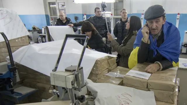 Члени регіонального виборчкому вивчають бюлетені на друкарні в Маріуполі. Через проблеми з бюлетенями місцева влада оголосила, що вибори в місті скасовані.