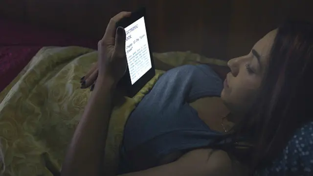 Женщина читает в постели