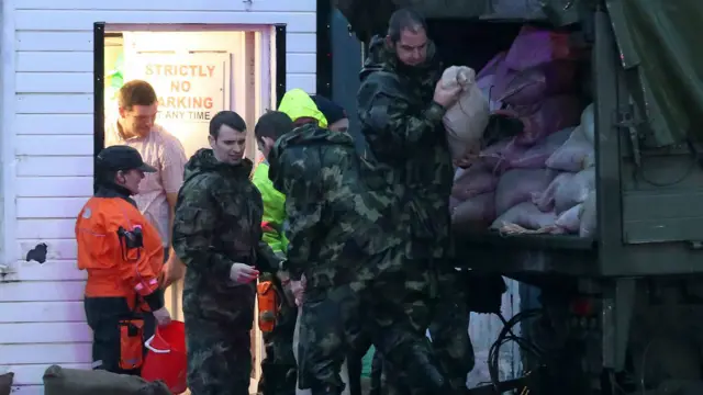 救援人员和士兵发送防洪沙包