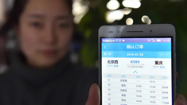 北京某女士通過12306手機購買2016年春運首天車票（新華社圖片26/11/2015）