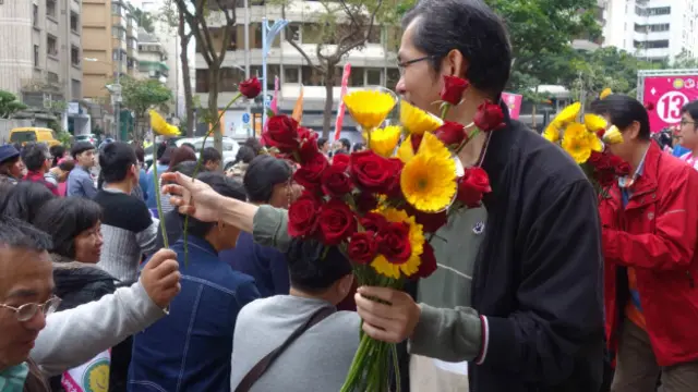 志工分送鲜花给支持者。