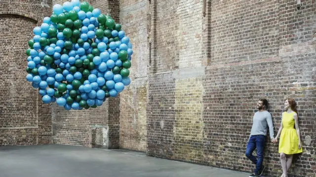 Una pareja mira globos de colores