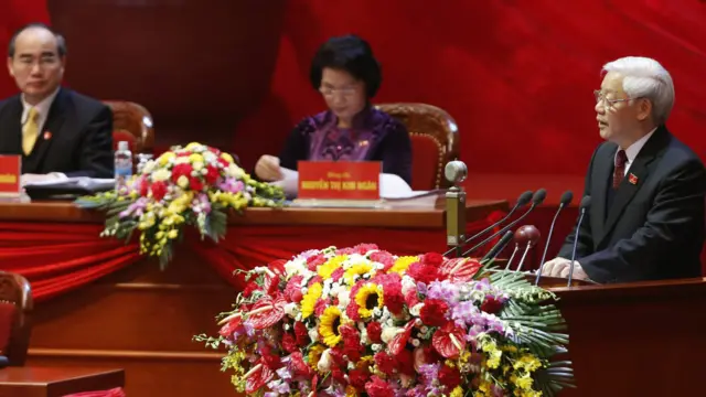 Tổng bí thư Nguyễn Phú Trọng đọc báo cáo văn kiện, đằng sau là Chủ tịch Mặt trận Tổ quốc Việt Nam Nguyễn Thiện Nhân và Phó Chủ tịch Quốc hội Nguyễn Thị Kim Ngân.