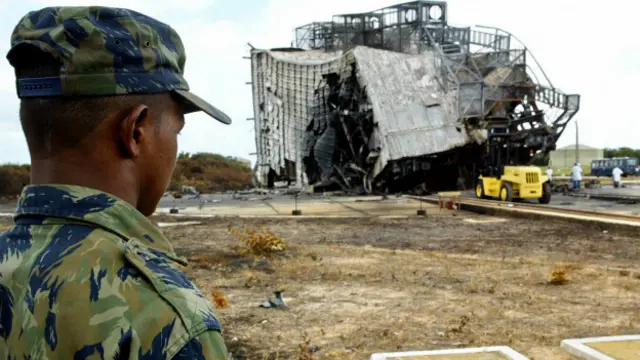 looks at the rubble of the satellite launch rocket