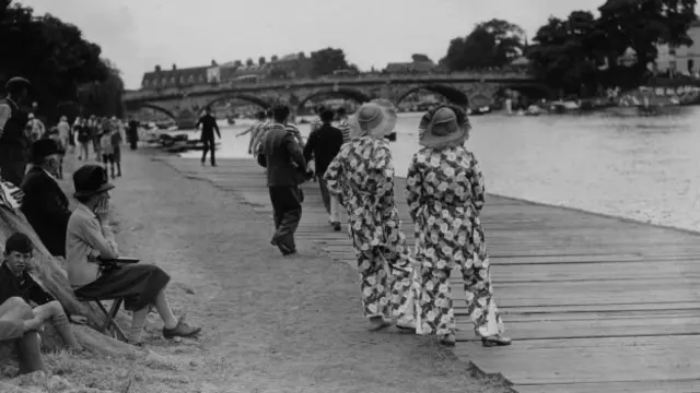 A couple of women wearing matching beach pyjamas