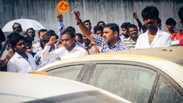 La subasta de autos afectados por las inundaciones atrae a decenas de compradores en Chennai.