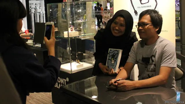 Eka Kurniawan bersama seorang penggemarnya dalam acara tanda tangan dalam novelnya 'O' yang baru diluncurkan.
