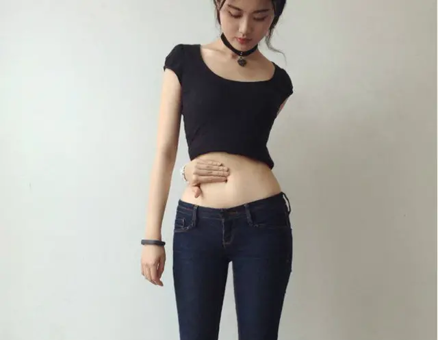 Joven china posando según el "reto del ombligo".