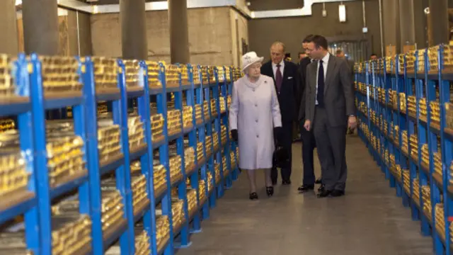 伊丽莎白二世女王2012年与菲利普亲王、爱丁堡公爵一同到访英格兰银行时，查看了里面存放的黄金。(图片来源：Getty Images)