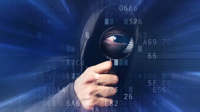 Una persona que se oculta detrás de códigos informáticos