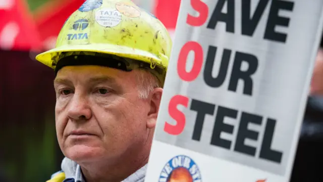 伦敦一名钢铁工人在示威中手举“拯救我们的钢铁”的纸牌