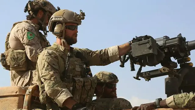 در تصاویر منتشر شده، نیروهای ویژه آمریکا با نشان یگان های مدافع خلق بر بازو دیده می شود