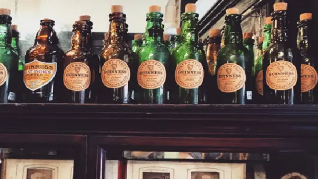 Старі пляшки Гіннесс та фотографії в аптеці Sweny's