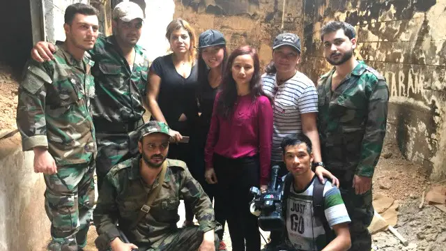 Nhóm làm chương trình chụp hình cùng quân chính phủ Syria (bà Lê Bình mặc áo màu đỏ thẫm)