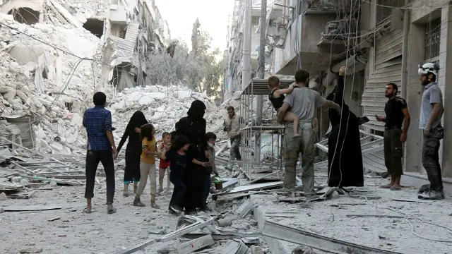 Một gia đình rời khỏi khu vực bị cho là có không kích xảy ra hôm 23/9 ở Aleppo