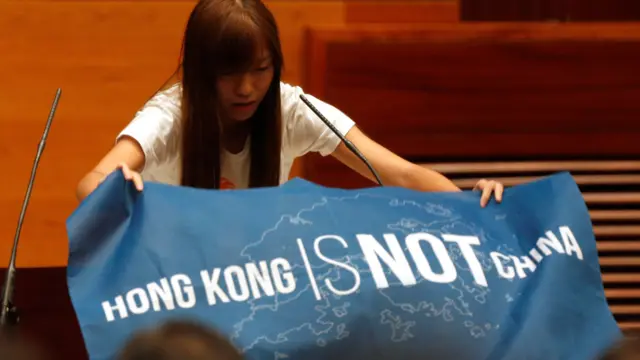 “青年新政”的游蕙祯展示“香港不是中国”（Hong Kong is not China）的蓝色旗帜