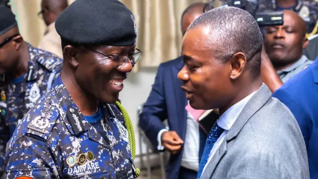 IGP in a handshake with superintendent Emmanuel Gyebi, one of the witnesses