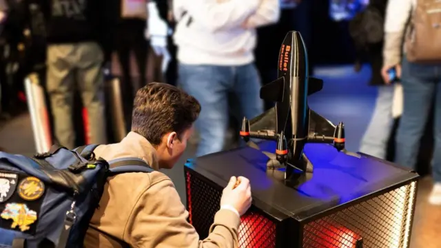 Чоловік з рюкзаком дивиться на дрон-перехоплювач