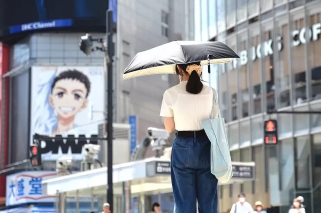 Mulher usando guarda-chuva paradamelhores casas de aposta futebolrua no Japão