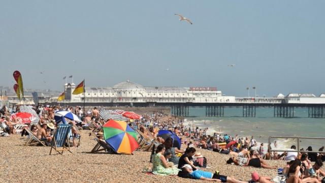 People sunbathe on the beach at Brighton