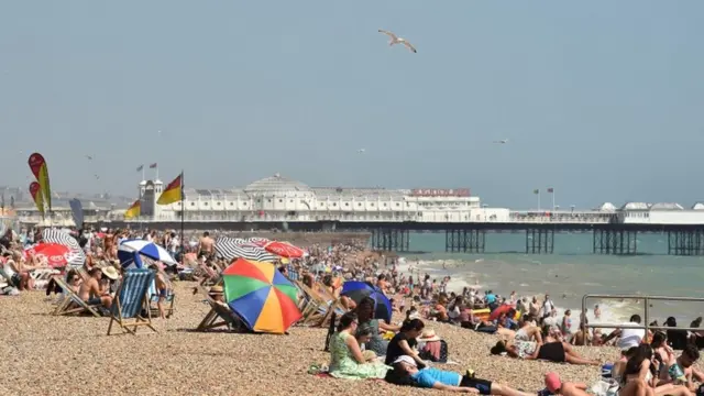 People sunbathe on the beach at Brighton