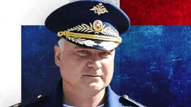 An image of Maj Gen Andrey Sukhovetsky over a treatment of the Russian flag