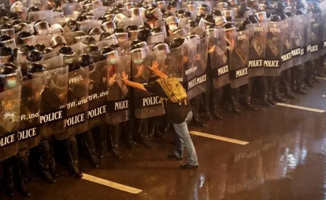 A man pushes against police officers during an anti-government protest, in Bangkok, Thailand October 16, 2020