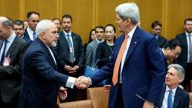 Foreign Minister of Iran, Mohammad Javad Zarif shakes hands with US Secretary of State John Kerry at the last working session of negotiations on July 14, 2015 in Vienna, Austria