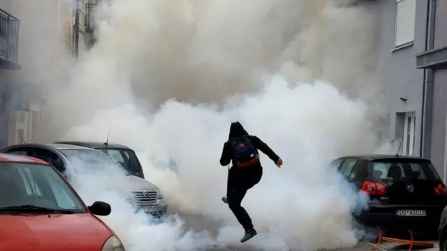 A protester is enveloped in tear gas in Montenegro