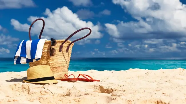 A beach bag on a sandy beach