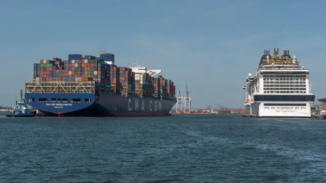 A huge container ship and a cruise ship seen in Southampton Docks, UK